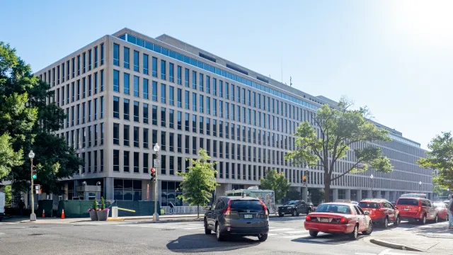 The Lyndon Baines Johnson Department of Education Building in Washington, D.C., a long pale federal office block with a columned entrance, photographed 21 June 2024. Photo by Ajay Suresh, CC BY 2.0, via Wikimedia Commons.